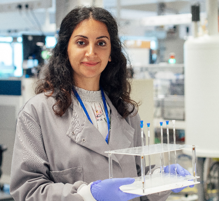 woman scientist with scientifc tubes in rack